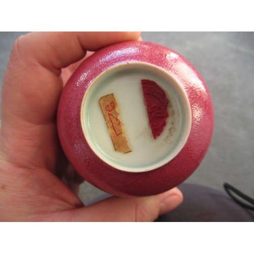 521 - Reproduction Chinese tea bowl with cerise mottled glaze, with wax part seal to base, 3.5ins diameter