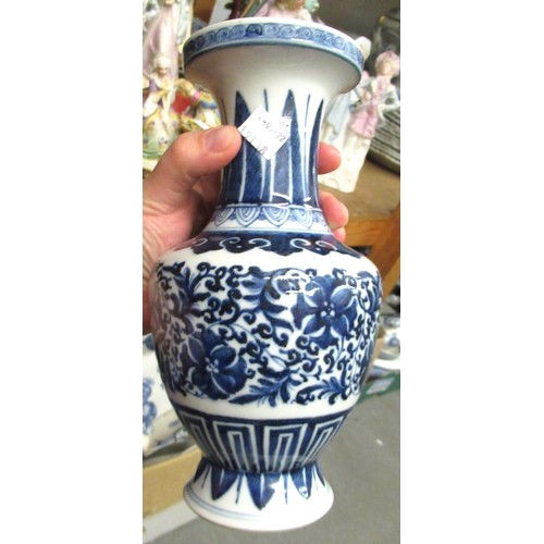 522 - Pair of reproduction Chinese blue and white floral decorated baluster form vases 9.5ins high, togeth... 