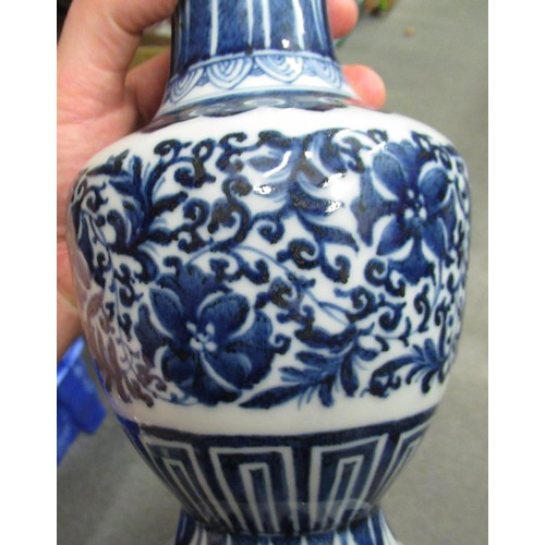 522 - Pair of reproduction Chinese blue and white floral decorated baluster form vases 9.5ins high, togeth... 