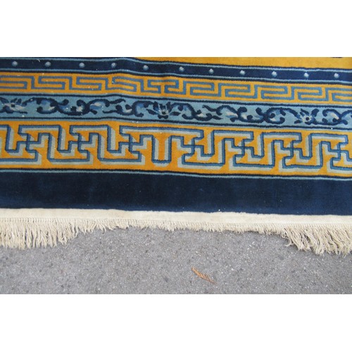 10 - Chinese woollen carpet of Art Deco design on yellow ground, 12ft x 9ft approximately