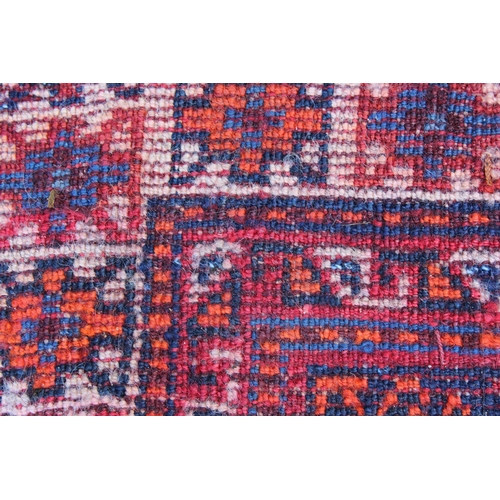 11 - Large Shiraz rug with a medallion and all-over stylised design on a red ground with blue corner desi... 