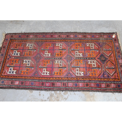 13 - Small Afghan rug with two rows of three gols on a wine ground with borders, 6ft x 3ft 2ins approxima... 