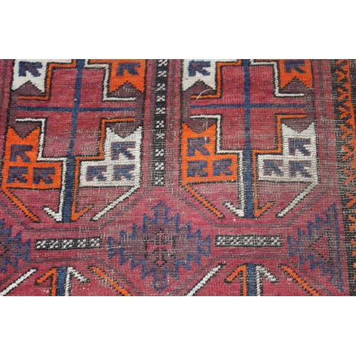 13 - Small Afghan rug with two rows of three gols on a wine ground with borders, 6ft x 3ft 2ins approxima... 