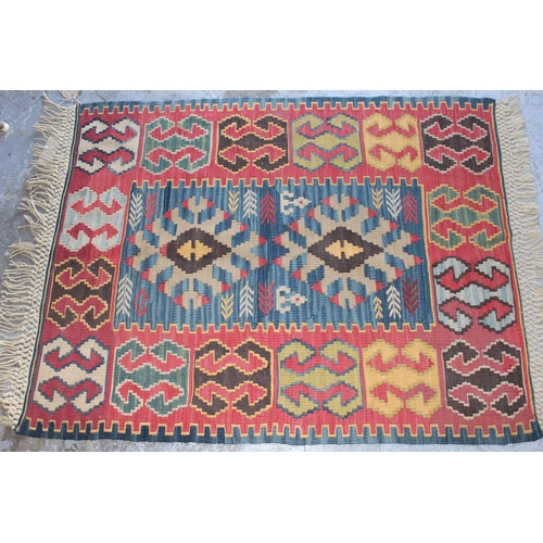 14 - Small part piled rug with a four panel design and tassel border, 4ft 8ins x 4ft 2ins approximately t... 