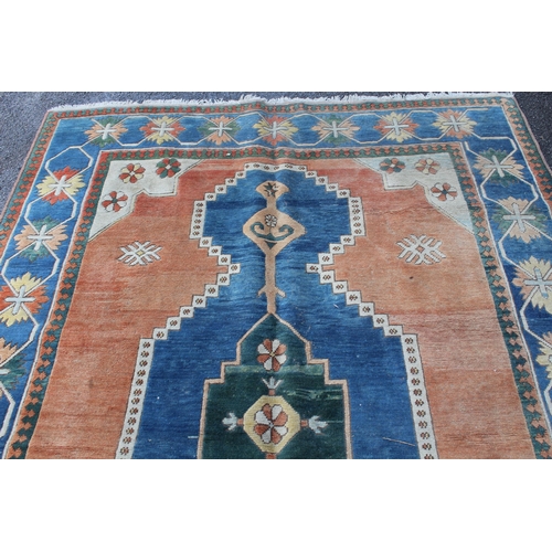 15 - Modern Turkish carpet with a central lobed medallion design on a terracotta ground with blue ground ... 