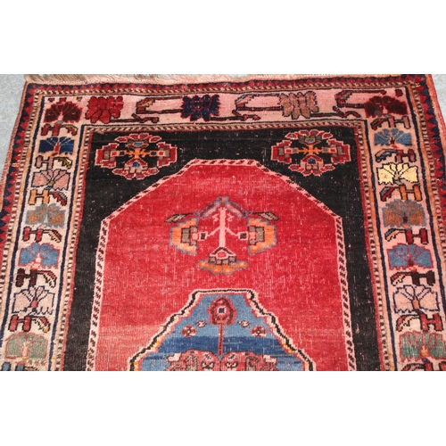 18 - Small south west Persian rug with a medallion and floral design on a red ground with borders, 4ft 10... 