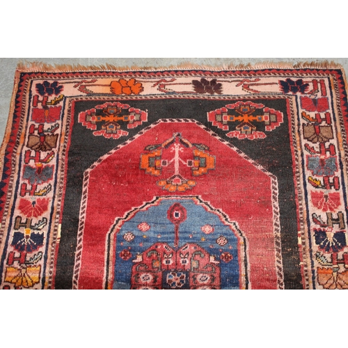 18 - Small south west Persian rug with a medallion and floral design on a red ground with borders, 4ft 10... 