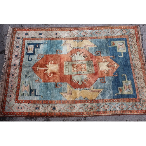 19 - Modern Turkish carpet with a central hooked medallion design on a blue and terracotta ground with bo... 