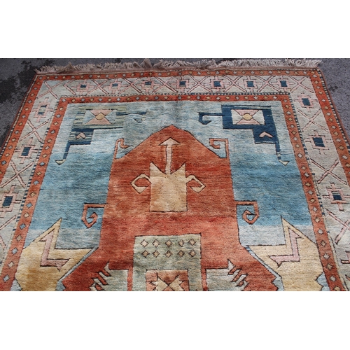 19 - Modern Turkish carpet with a central hooked medallion design on a blue and terracotta ground with bo... 