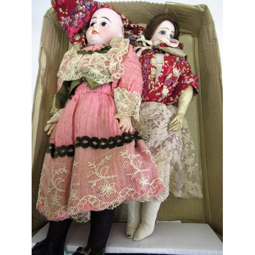 199 - Small late 19th / early 20th Century bisque headed doll with fixed eyes and kid leather body, wearin... 