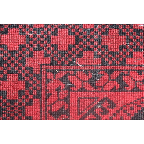 2 - Afghan carpet on wine ground, 115ins x 79ins