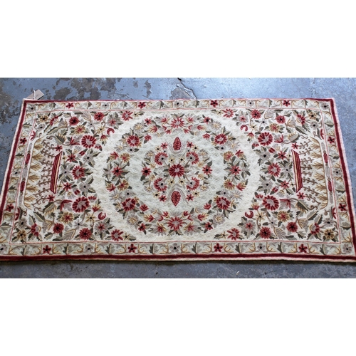 20 - Small Numdah rug with a medallion and floral design on an ivory ground with narrow border, 4ft x 2ft... 