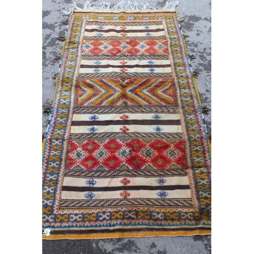 21 - Kelim and part piled rug of alternating panel design with borders, 6ft 8ins x 3ft 8ins approximately