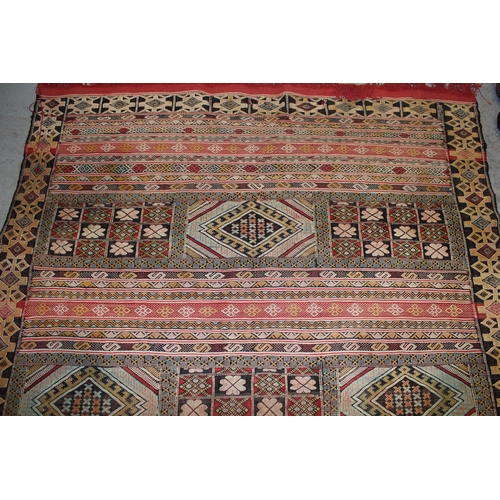 24 - Soumak rug of polychrome panel and banded design in shades of red, pale blue, cream and yellow, 7ft ... 