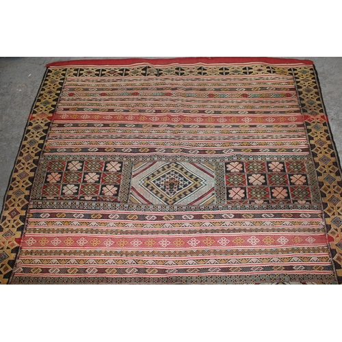 24 - Soumak rug of polychrome panel and banded design in shades of red, pale blue, cream and yellow, 7ft ... 