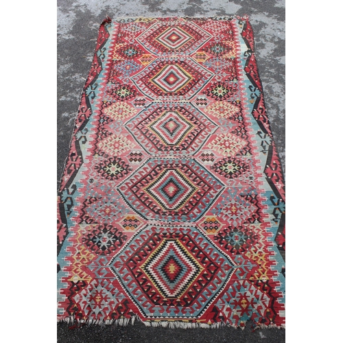 25 - Large Kelim rug with a five medallion and all-over stylised floral design in multiple colours (holes... 