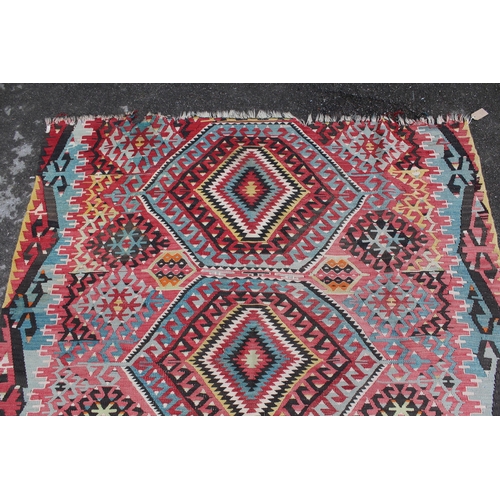 25 - Large Kelim rug with a five medallion and all-over stylised floral design in multiple colours (holes... 