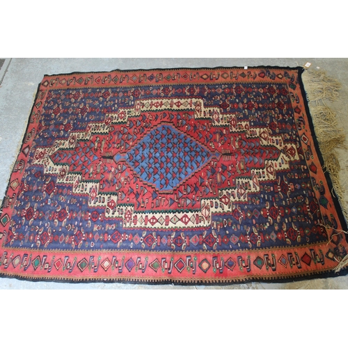 29 - Senneh Kelim rug with a medallion and all-over stylised design in shades of red, blue and cream, 4ft... 