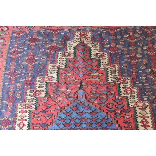 29 - Senneh Kelim rug with a medallion and all-over stylised design in shades of red, blue and cream, 4ft... 