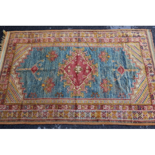 3 - Turkish rug with central medallion in shades of red, blue and orange with a multiple border, 8ft x 5... 