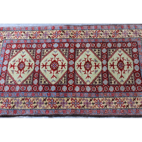 32 - Small Indo Persian rug with an all-over stylised design on a red ground with borders