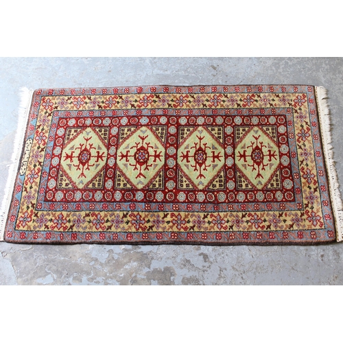 32 - Small Indo Persian rug with an all-over stylised design on a red ground with borders