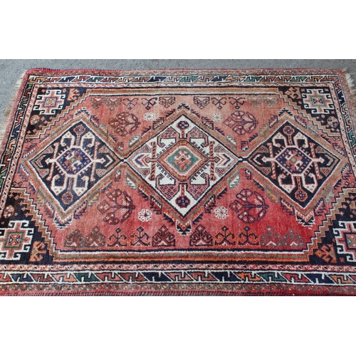 36 - Small South West Persian rug with a triple medallion design on a rose ground with borders, 5ft 3ins ... 