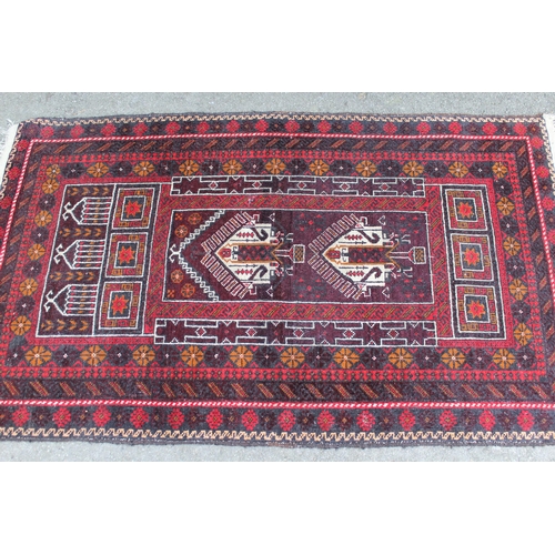 39 - Afghan prayer rug with a twin medallion and Mihrab design on a dark ground with multiple borders, 5f... 