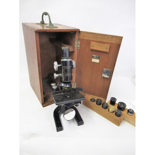 395 - 20th Century microscope by Cooke, Troughton & Simms Limited, black japanned finish in original mahog... 