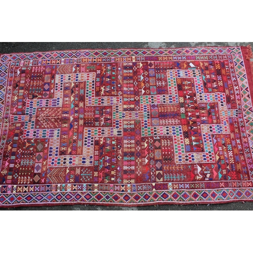 4 - Soumak rug with a twin medallion and all-over polychrome design on a wine ground with borders, 7ft 6... 