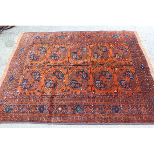 40 - Afghan rug with two rows of five gols on a rust ground with multiple border, 6ft 2ins x 5ft approxim... 