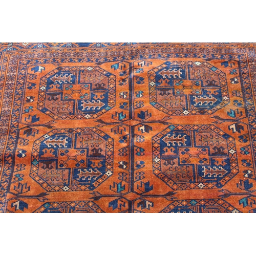 40 - Afghan rug with two rows of five gols on a rust ground with multiple border, 6ft 2ins x 5ft approxim... 