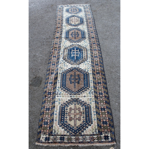 41 - Modern Turkish runner with six medallions on a cream ground with borders, 9ft 4ins x 2ft 6ins approx... 