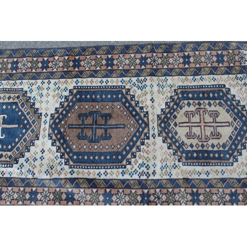 41 - Modern Turkish runner with six medallions on a cream ground with borders, 9ft 4ins x 2ft 6ins approx... 