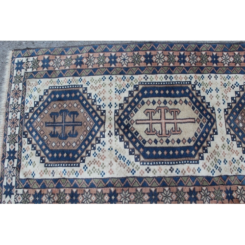 41 - Modern Turkish runner with six medallions on a cream ground with borders, 9ft 4ins x 2ft 6ins approx... 