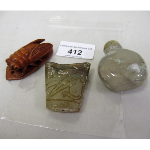 412 - Small hardstone snuff bottle, carved wooden net ski and a jadeite cup