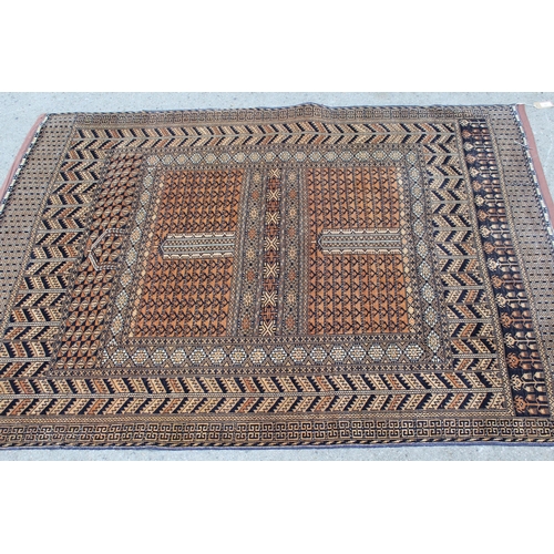 42 - Afghan rug with a twin panel design and multiple borders on a pale terracotta ground, 5ft 8ins x 4ft... 