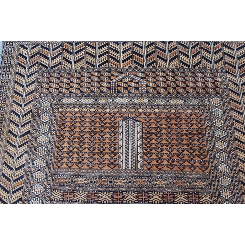 42 - Afghan rug with a twin panel design and multiple borders on a pale terracotta ground, 5ft 8ins x 4ft... 