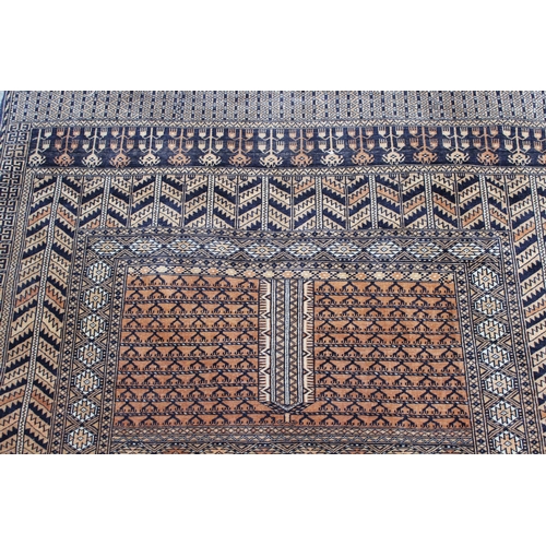 42 - Afghan rug with a twin panel design and multiple borders on a pale terracotta ground, 5ft 8ins x 4ft... 