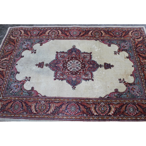 44 - Tabriz rug with a medallion and plain design within a rosette border, 6ft x 4ft approximately (vario... 