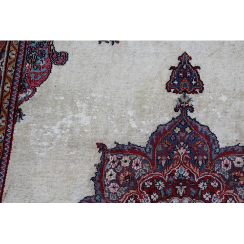 44 - Tabriz rug with a medallion and plain design within a rosette border, 6ft x 4ft approximately (vario... 