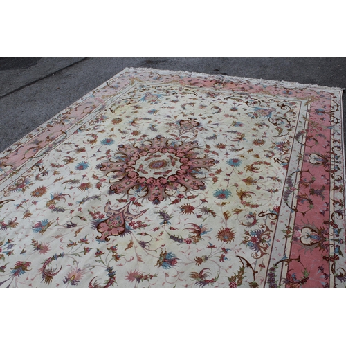 46 - Modern Tabriz part silk carpet with a medallion and all-over floral design on an ivory ground with b... 