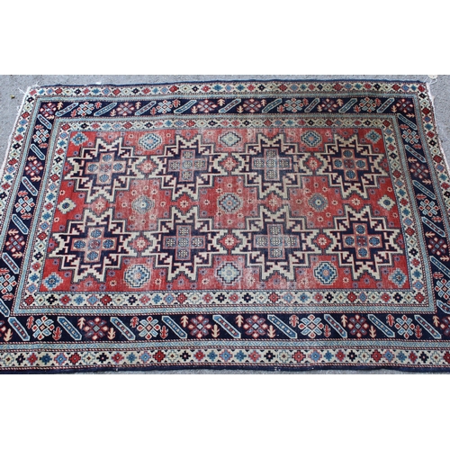 53 - Shirvan rug with eight medallion design on a brick red field with borders, 4ft 10ins x 3ft 8ins appr... 