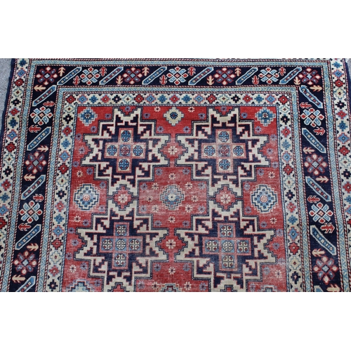 53 - Shirvan rug with eight medallion design on a brick red field with borders, 4ft 10ins x 3ft 8ins appr... 