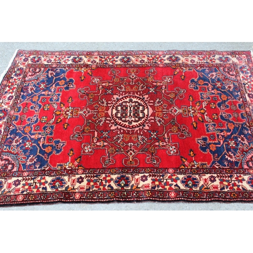 54 - Tabriz rug with a medallion design on a red ground, with blue corner designs and borders, 6ft x 4ft ... 