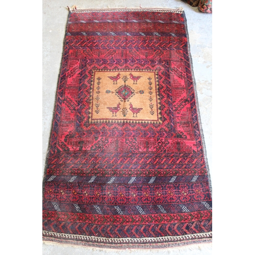 56 - Belouch rug with a single medallion design on a banded red ground, 5ft 6ins x 3ft approximately