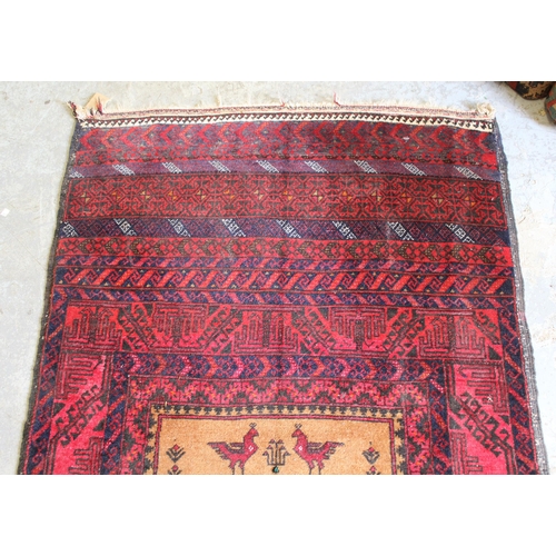 56 - Belouch rug with a single medallion design on a banded red ground, 5ft 6ins x 3ft approximately