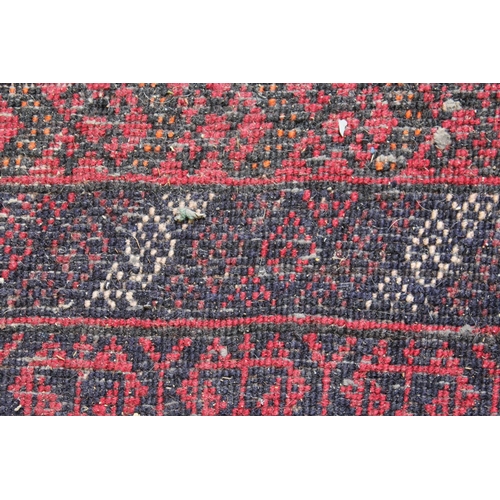 56 - Belouch rug with a single medallion design on a banded red ground, 5ft 6ins x 3ft approximately