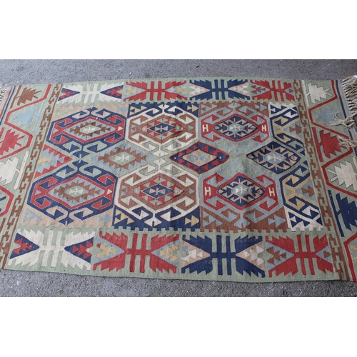 59 - Kelim rug of geometric design on pale green ground, 6ft x 3ft6ins