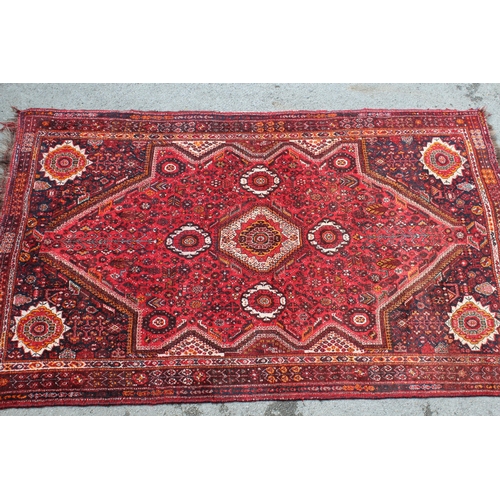 60A - Shiraz carpet with a medallion and all-over floral design, 9ft x 7ft approximately